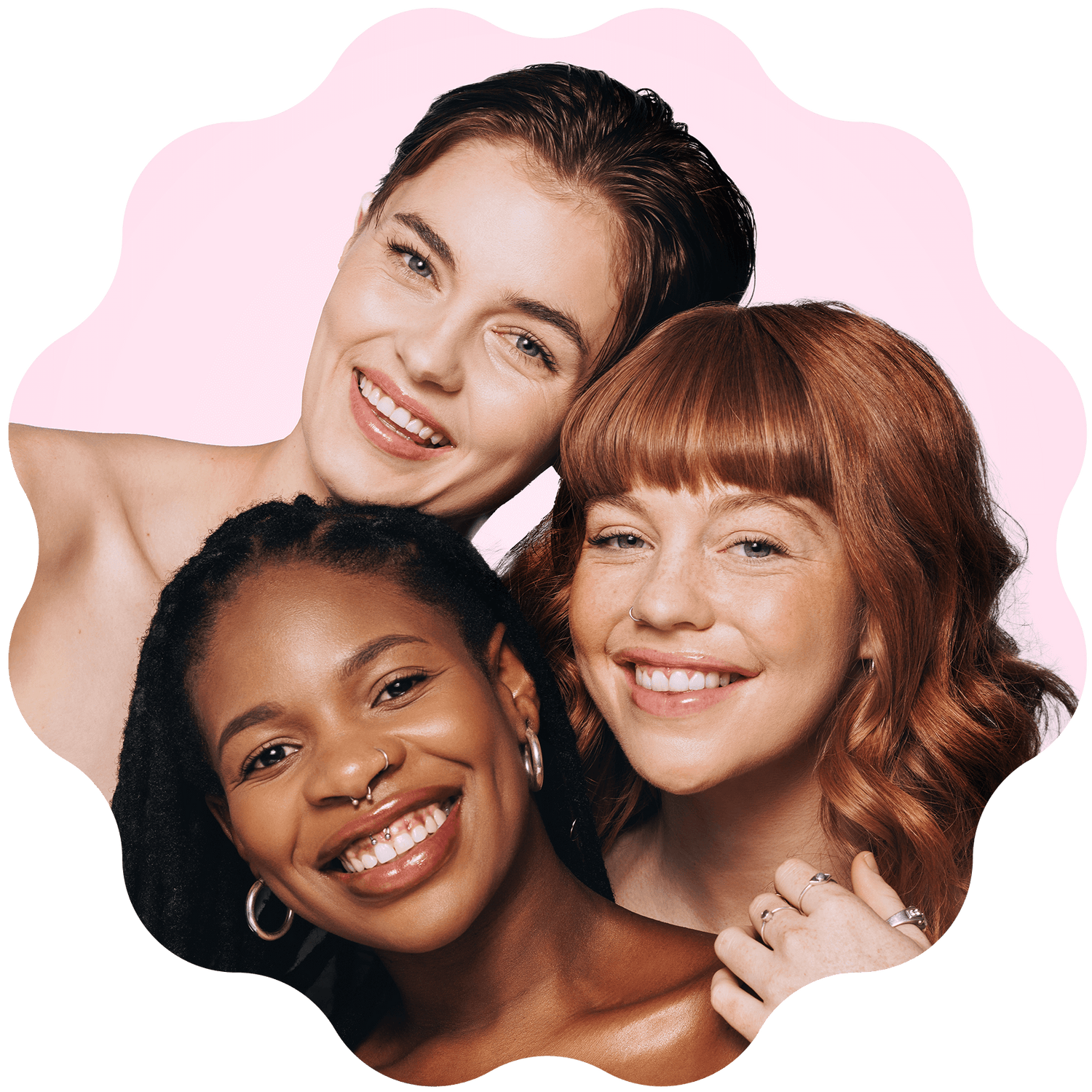 Three women of diverse ethnicities smiling